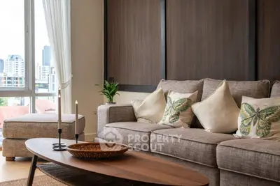 Elegant living room with cozy sofa, butterfly pillows, and city view through large window.