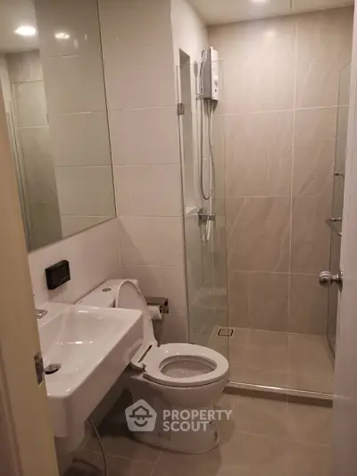 Modern bathroom with sleek shower and contemporary fixtures in a stylish apartment.