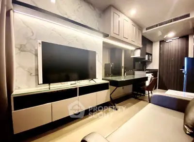 Modern living room with sleek TV setup and stylish furniture in a contemporary apartment.