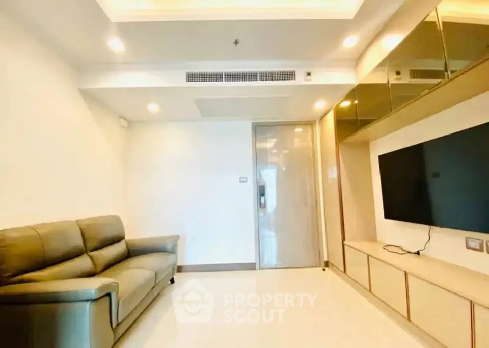 Modern living room with sleek design and wall-mounted TV in a bright apartment.