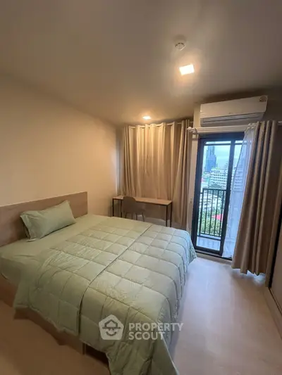 Cozy bedroom with city view and balcony access, featuring modern decor and natural light.