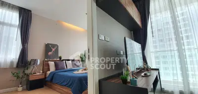 Modern bedroom with stylish decor and large windows offering natural light.