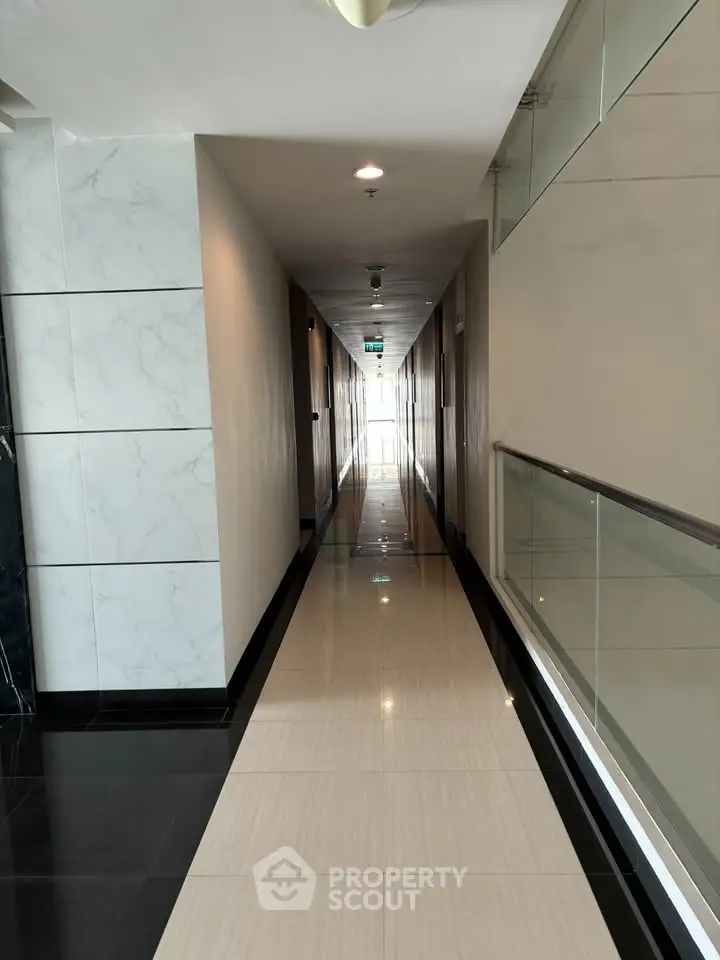 Modern corridor with sleek design and polished flooring in a contemporary building.