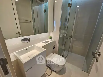 Modern bathroom with sleek fixtures and glass shower enclosure