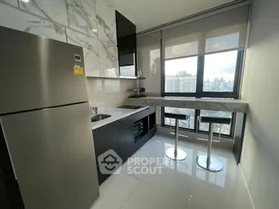 Modern kitchen with sleek appliances and city view, featuring marble countertops and high-rise windows.