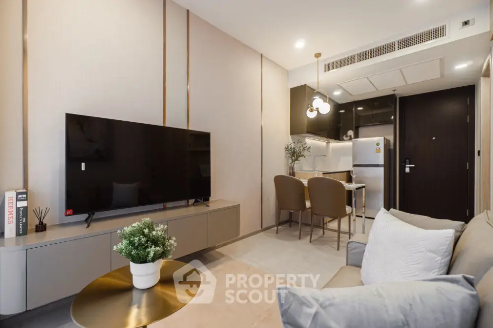 Modern living room with sleek furniture and open kitchen layout