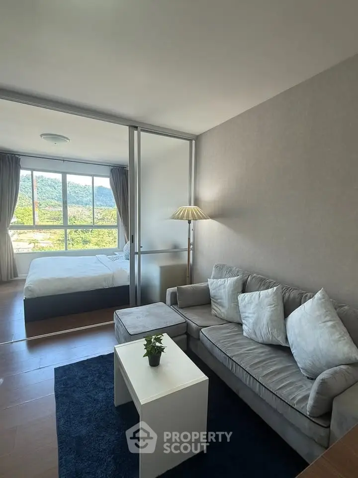 Modern living room with cozy sofa and scenic bedroom view