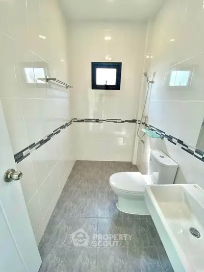 Modern bathroom with sleek white tiles and compact design