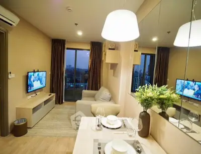 Modern living room with cozy sofa, dining area, and city view from balcony.