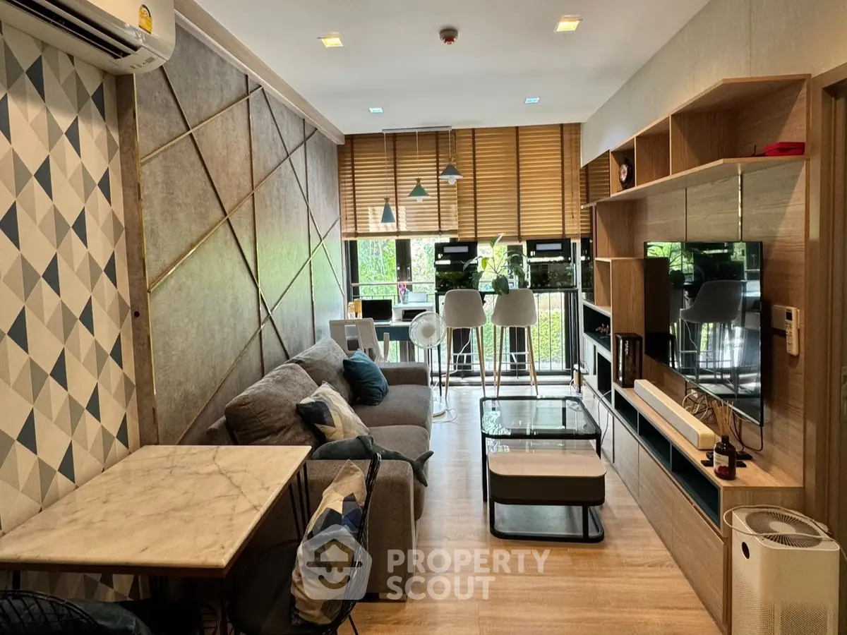 Modern living room with stylish decor and open layout, featuring a cozy sofa and elegant dining area.