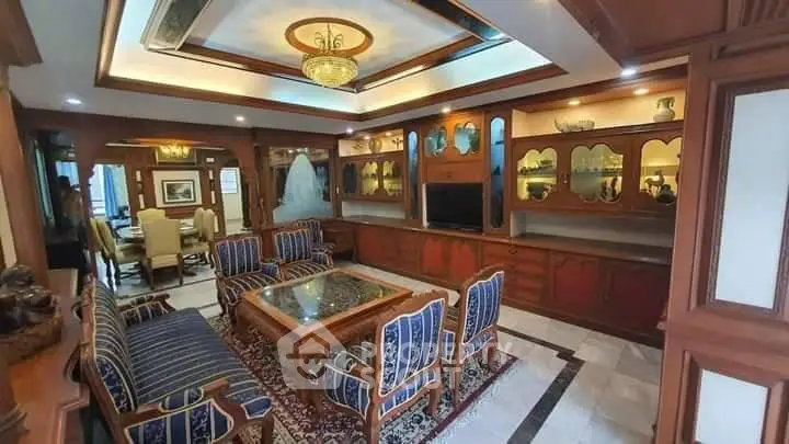 Luxurious living room with elegant wooden decor and plush seating in a sophisticated home.