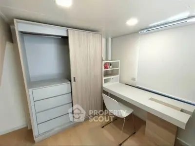 Modern study room with sleek desk and built-in wardrobe, perfect for productivity and organization.