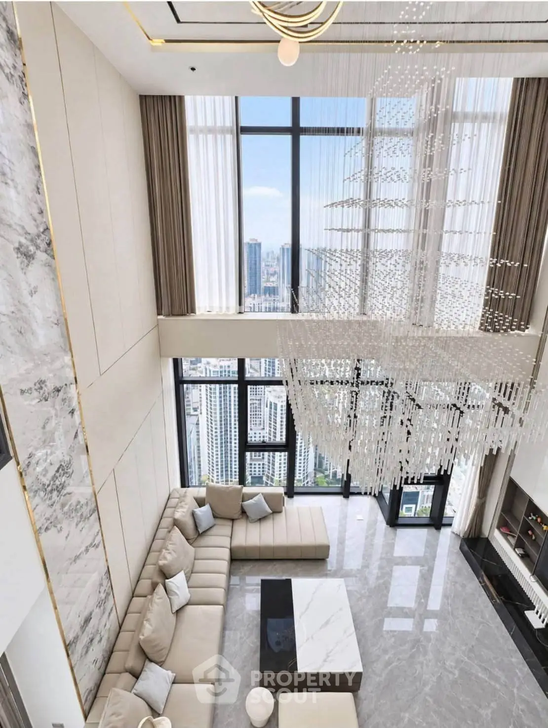 Luxurious high-rise living room with floor-to-ceiling windows and stunning city views.