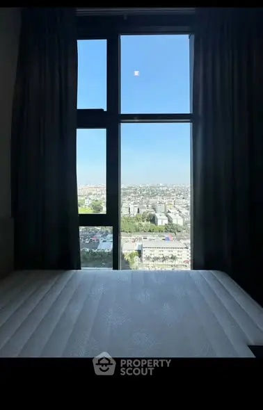 Stunning city view from a modern bedroom window, showcasing urban landscape and natural light.