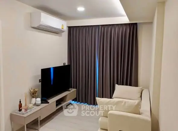 Modern living room with sleek design, featuring a cozy sofa, flat-screen TV, and elegant curtains.