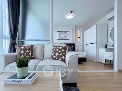 Modern living room with stylish decor and cozy seating in a bright apartment.