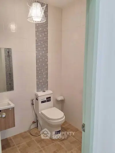 Modern bathroom with sleek toilet and stylish tile design