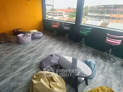 Spacious balcony with modern seating and city view, perfect for relaxation.