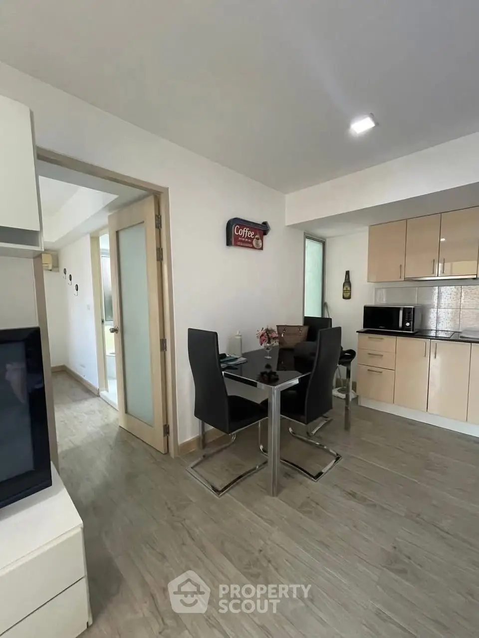 Modern kitchen and dining area with sleek design and wooden flooring