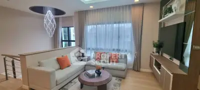 Elegant living room with modern chandelier and cozy seating area