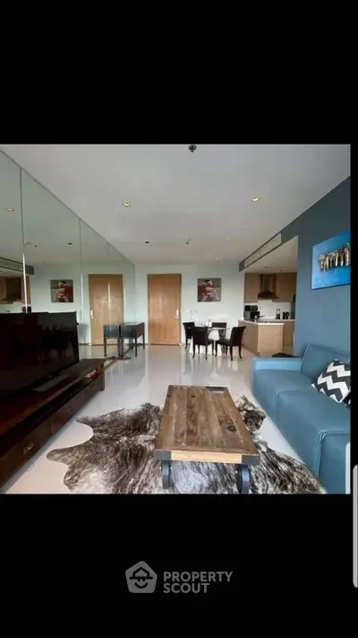 Modern living room with stylish decor and open kitchen layout in a contemporary apartment.