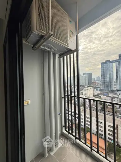 High-rise balcony with city view and air conditioning unit, perfect for urban living.