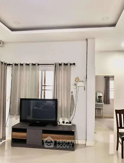 Modern living room with sleek TV setup and neutral decor