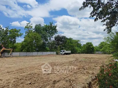 Expansive vacant land with lush greenery, perfect for development opportunities.