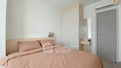 Cozy bedroom with modern decor and built-in wardrobe in a stylish apartment.