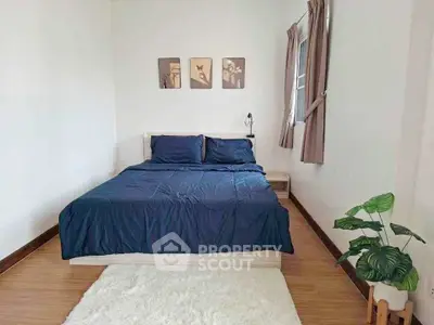Cozy bedroom with stylish decor and natural light, perfect for relaxation and comfort.