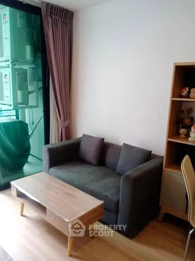 Cozy living room with modern sofa and wooden coffee table, perfect for relaxation.
