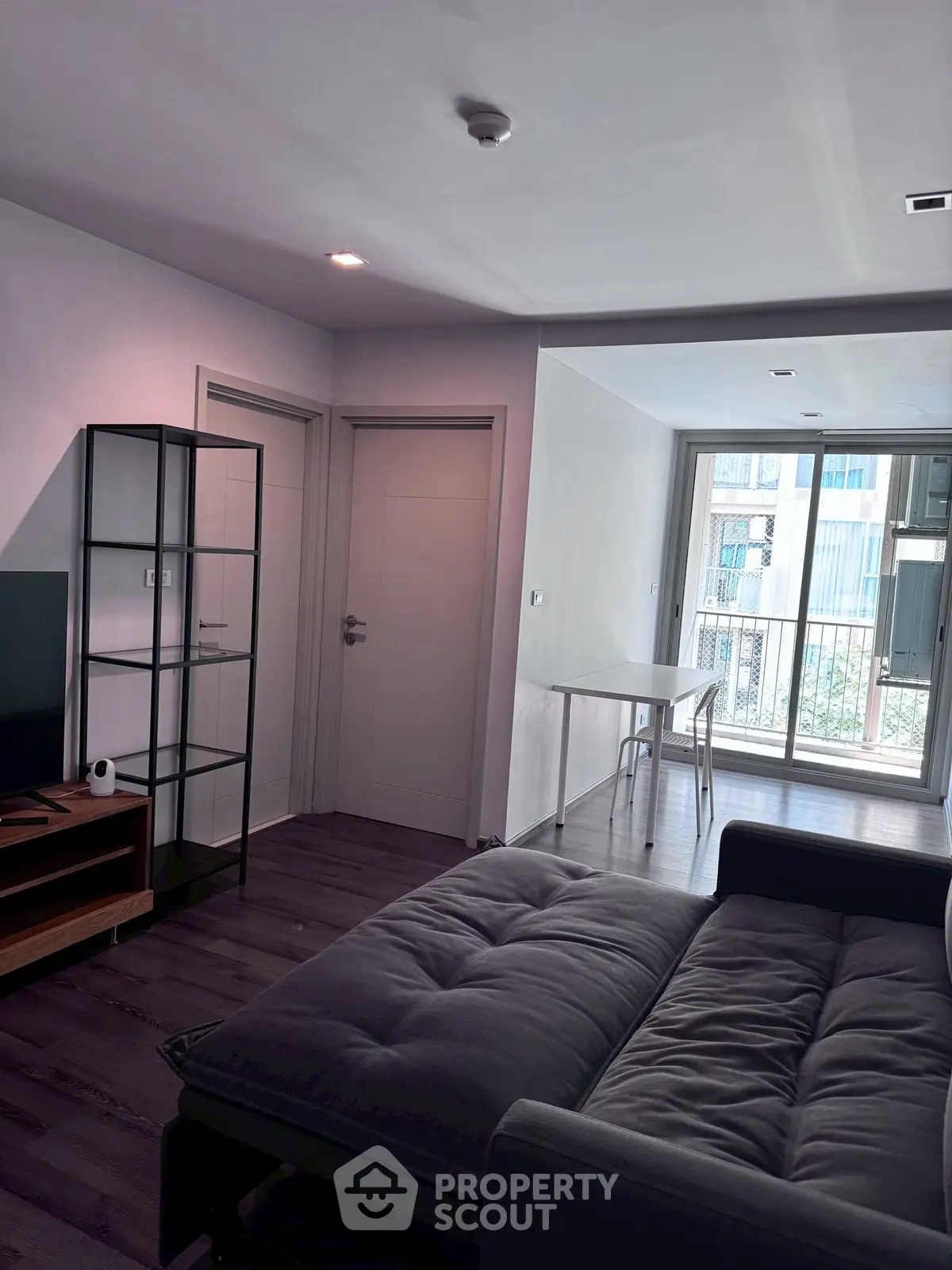 Modern living room with sleek furniture and large windows for natural light.