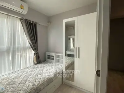Cozy bedroom with natural light, modern wardrobe, and air conditioning in a stylish apartment.