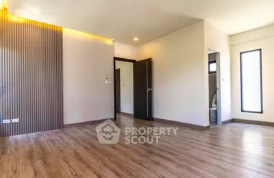 Spacious modern living room with wooden flooring and ambient lighting