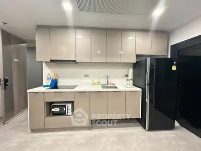 Modern kitchen with sleek cabinetry and appliances in a contemporary apartment.