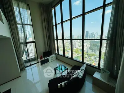 Stunning high-rise living room with floor-to-ceiling windows and panoramic city views.