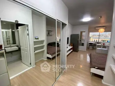 Modern studio apartment with open layout and sleek design, featuring a cozy living area and stylish bathroom.