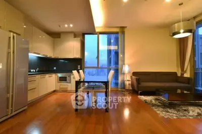 Modern open-plan living room with sleek kitchen and city view.