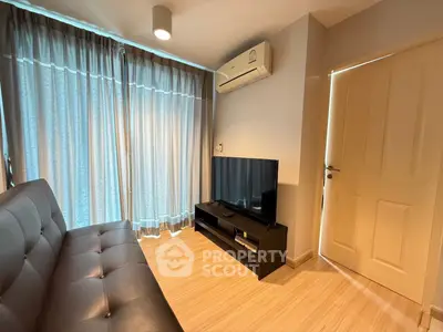 Cozy living room with modern sofa, TV, and air conditioning, featuring elegant curtains and wooden flooring.
