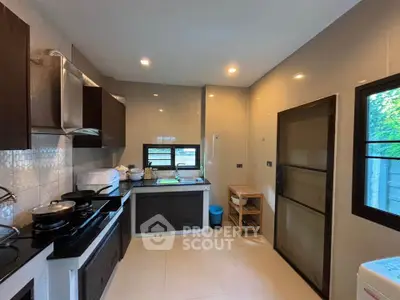 Modern kitchen with sleek cabinets and ample natural light