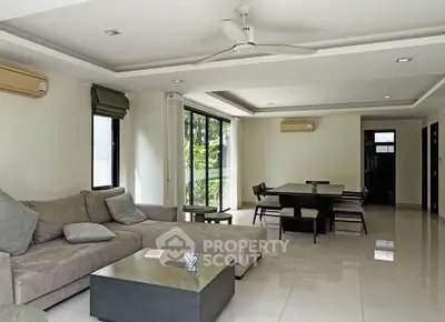 Spacious modern living room with elegant dining area and garden view