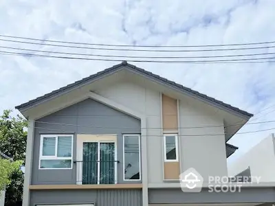 Modern two-story house with stylish facade and large windows