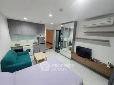 Modern studio apartment with compact kitchen and cozy living area