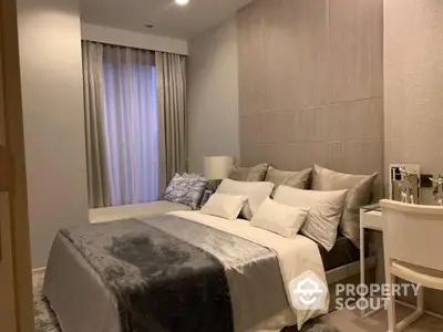 Elegantly designed bedroom with plush bedding, modern furnishings, and soft lighting, creating a serene and inviting atmosphere.