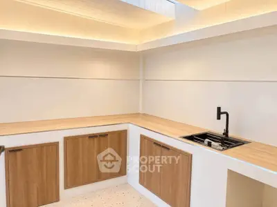 Modern kitchen with sleek wooden cabinets and minimalist design
