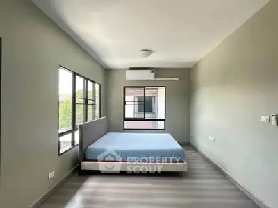 Spacious bedroom with modern design and large windows for natural light