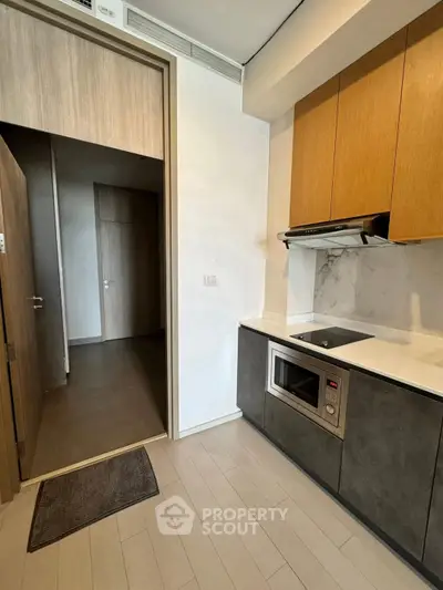 Modern kitchen with sleek cabinetry and built-in appliances in a stylish apartment.
