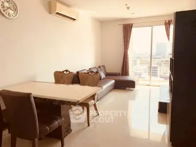 Spacious living room with modern furniture and city view from large windows.