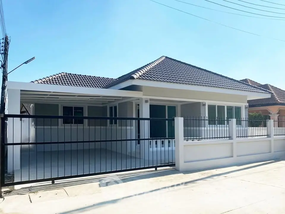 Charming single-story house with modern design and spacious driveway in a serene neighborhood.