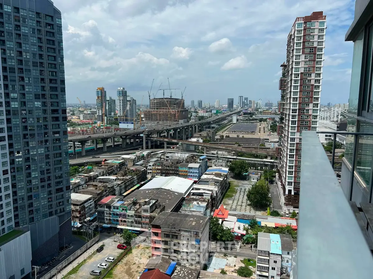 Stunning cityscape view from high-rise balcony showcasing urban skyline and modern architecture.